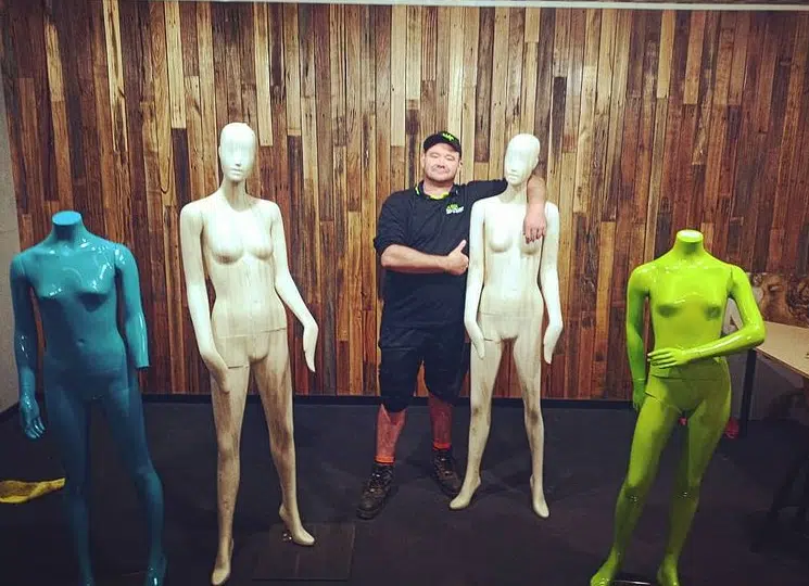 Junk dude standing with mannequins