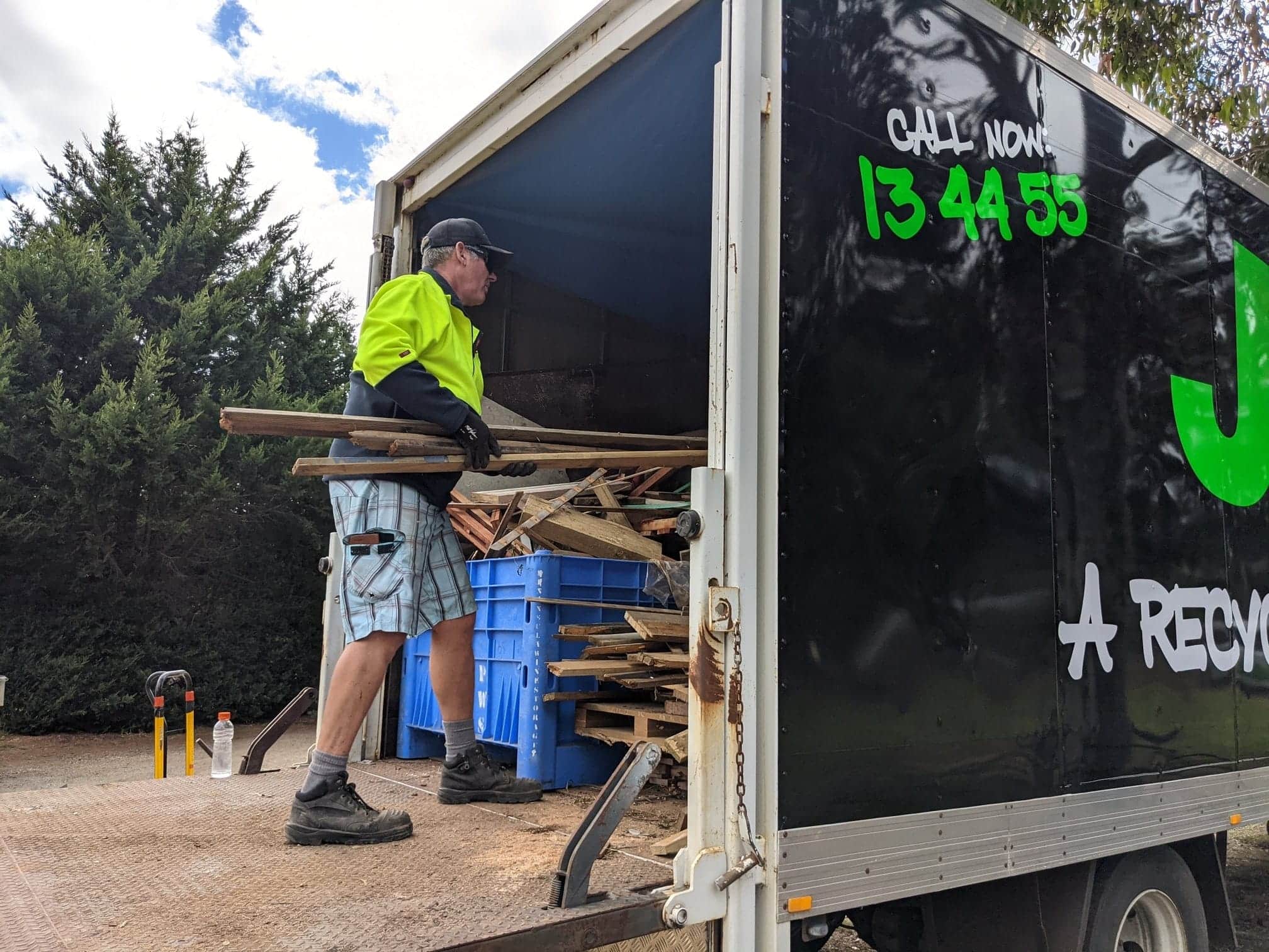 A Man Carrying the Woods Inside the Truck