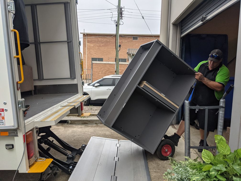 A Person Moving a Cabinet