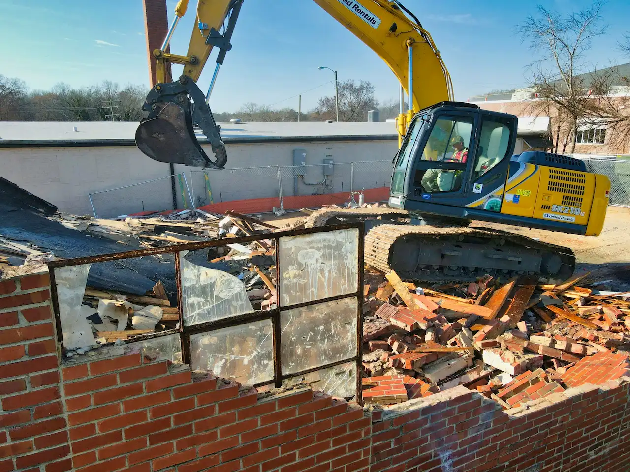 A Building That is Being Demolished by an Excavator